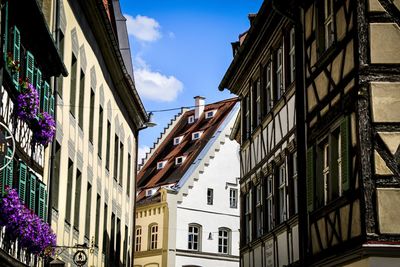 Low angle view of buildings in town against sky