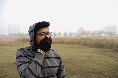 Portrait of man standing on field