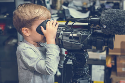 Boy using television camera