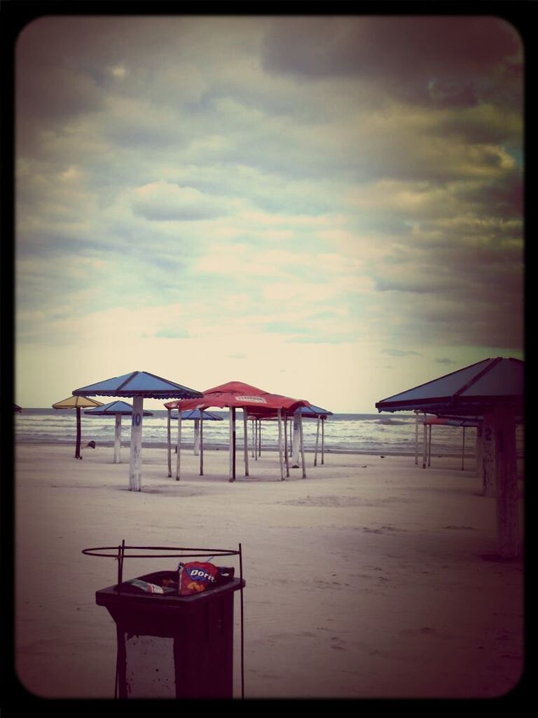 sea, sky, beach, built structure, water, auto post production filter, horizon over water, transfer print, architecture, tranquility, cloud - sky, sand, tranquil scene, scenics, chair, absence, nature, shore, beauty in nature, cloud