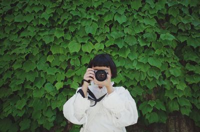 Portrait of man photographing outdoors