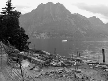 Scenic view of lake by mountains against sky