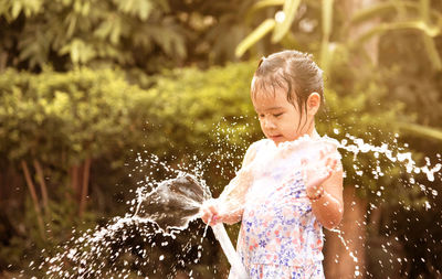 Full length of boy splashing water