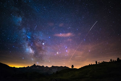 Scenic view of mountains against sky at night