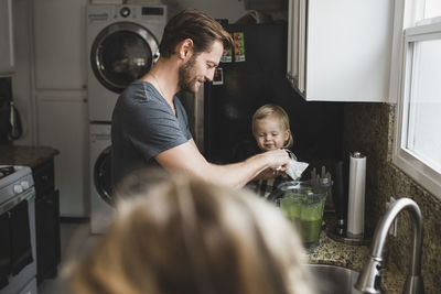 Midsection of mother and daughter at home