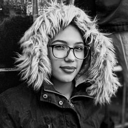 Close-up portrait of smiling young woman in warm clothing