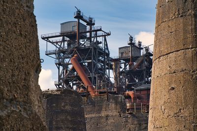 Low angle view of old construction site against sky
