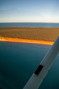 Close-up of sea seen through airplane window