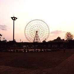 Low angle view of ferris wheel against sky