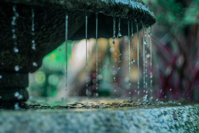 Close-up of water falling from metal during rainy season