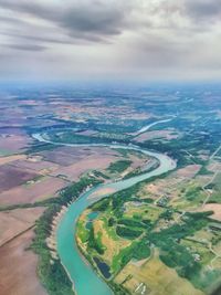 Aerial view of landscape against cloudy sky