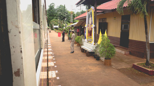 Footpath amidst buildings in city