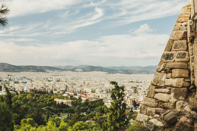 Aerial view of townscape and mountains against sky