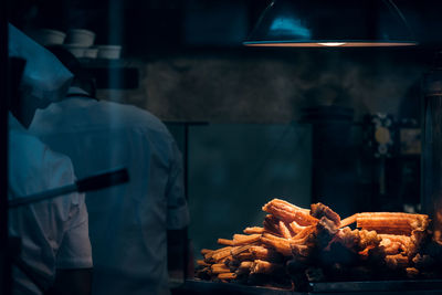 Midsection of man preparing food in restaurant