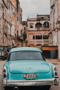 Car on street against buildings in city