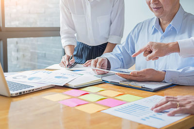 Low section of people working on table