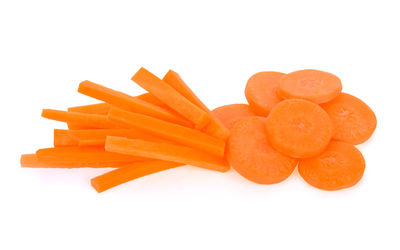 Close-up of orange slices over white background