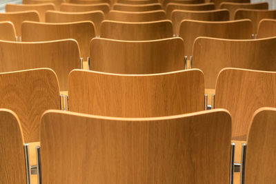 Full frame shot of empty wooden chairs