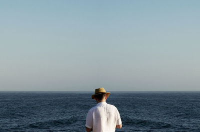 Rear view of man looking at sea