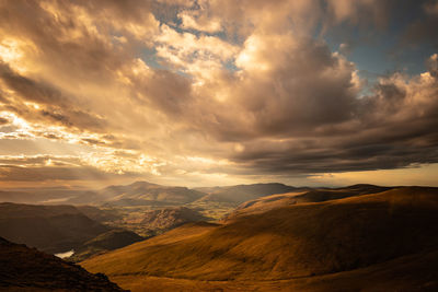 Scenic view of dramatic landscape against sky during sunset