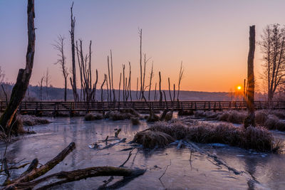 Scenic view of frozen lake against sky during winter