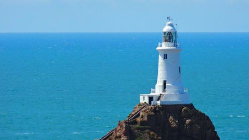 Scenic view of lighthouse on cliff