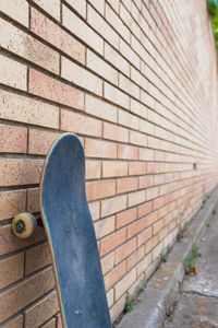Low section of skateboard on stone wall