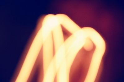 Close-up of burning candle in dark room