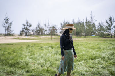 Portrait of woman standing on field