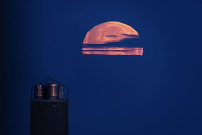 Low angle view of tower against sky at night