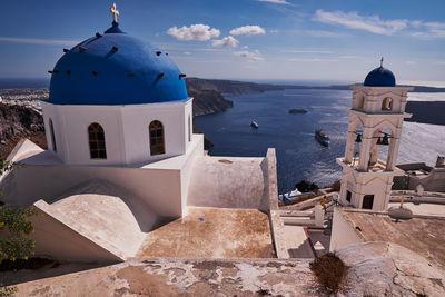 Anastasis church with its blue dome and tower in imerovigli village, santorini, greece