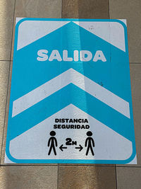 Close-up of arrow sign on road