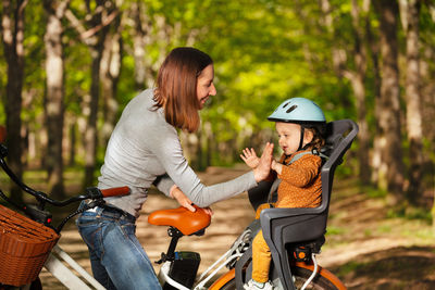 Side view of woman riding bicycle