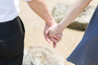 Young couple touch hand together on the beach