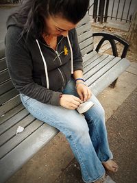 High angle view of woman sitting on seat