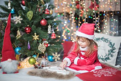 Portrait of girl playing christmas tree