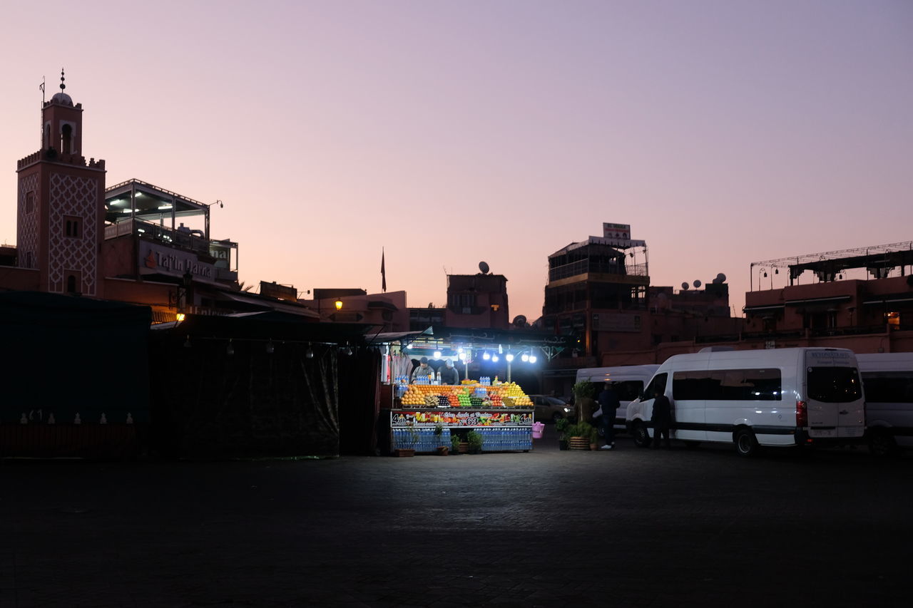 ILLUMINATED CITY AGAINST SKY DURING SUNSET