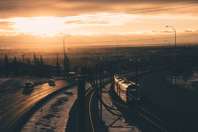 High angle view of railroad tracks against sky during sunset