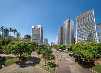 Buildings in city against clear sky