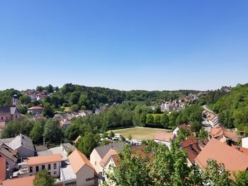 High angle view of townscape against clear blue sky