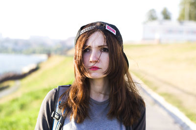 Beautiful young woman wearing sunglasses on field