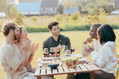 Friends toasting drinks on table