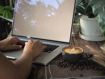 Midsection of coffee cup on table