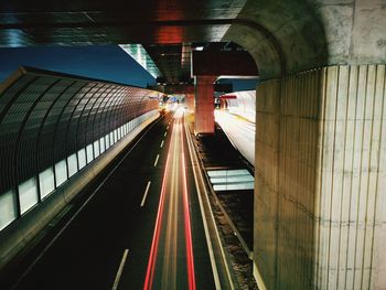 Light trails on railroad tracks in city at night