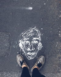 Low section of person standing on road