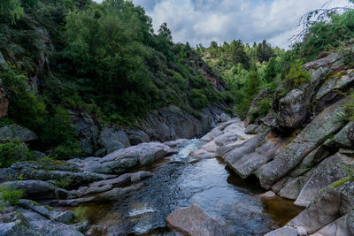 Scenic view of waterfall against sky