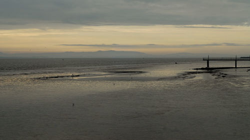 View of calm beach at sunset