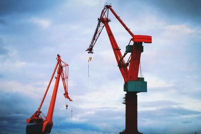 Red crane against sky