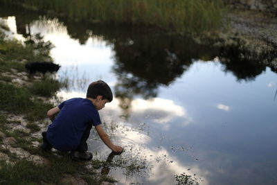 Rear view of boy in lake