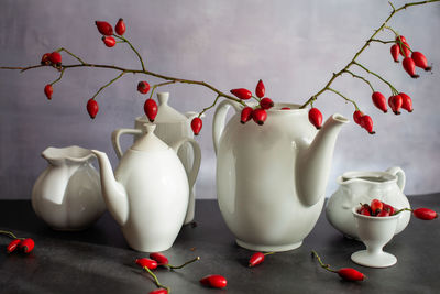 Rosehip tea in white crockery pot